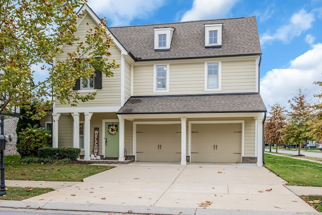 view of front of property featuring a front yard and a garage