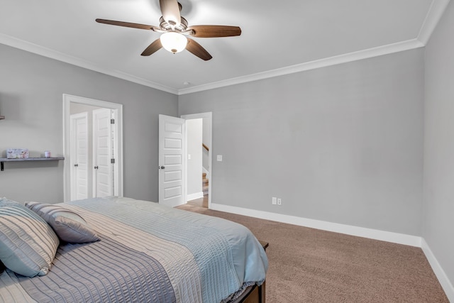 carpeted bedroom with ceiling fan and ornamental molding