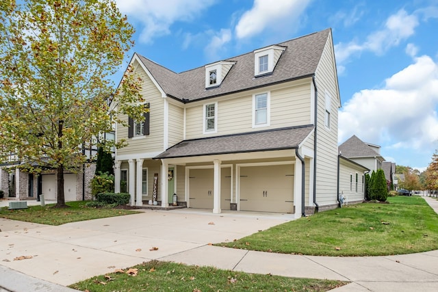 view of front of property featuring central AC unit, a front yard, and a garage