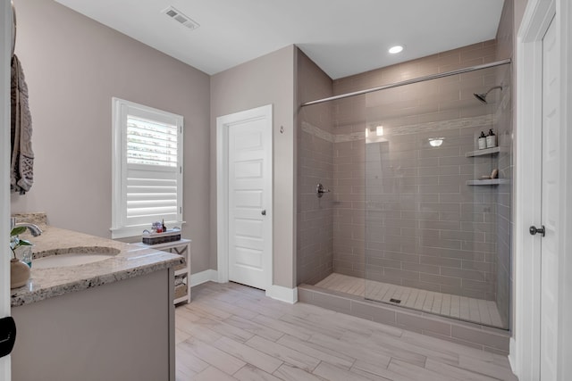 bathroom with vanity and tiled shower