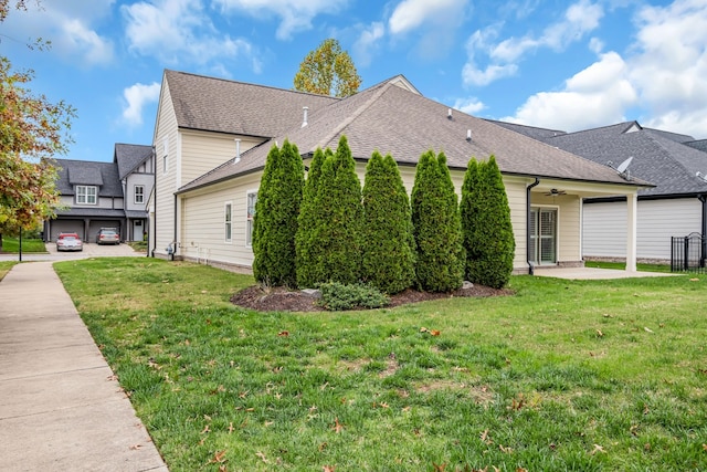 view of home's exterior featuring ceiling fan and a yard