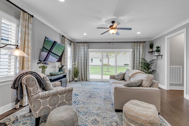 living room with dark hardwood / wood-style floors, ceiling fan, and crown molding