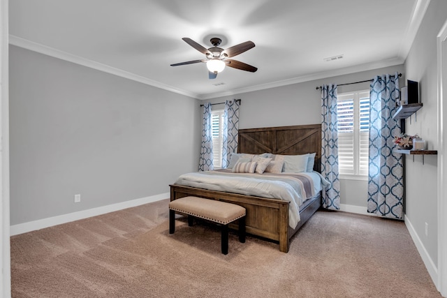 bedroom with ceiling fan, ornamental molding, carpet floors, and multiple windows