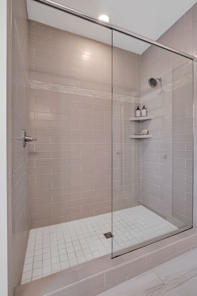 bathroom with a tile shower