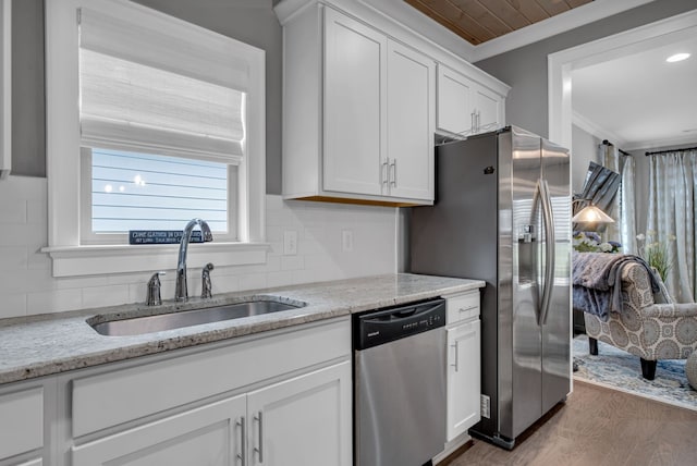 kitchen with appliances with stainless steel finishes, dark hardwood / wood-style flooring, backsplash, sink, and white cabinetry