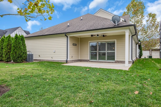 back of property with a lawn, ceiling fan, and a patio