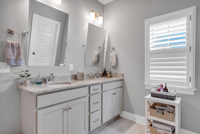 bathroom featuring hardwood / wood-style flooring and vanity