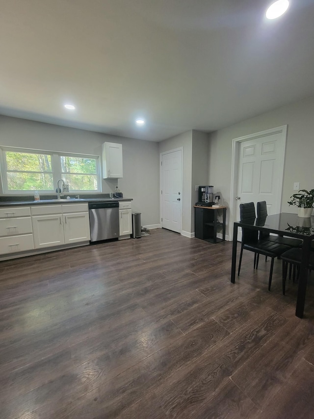 interior space with sink, stainless steel dishwasher, dark hardwood / wood-style floors, and white cabinets