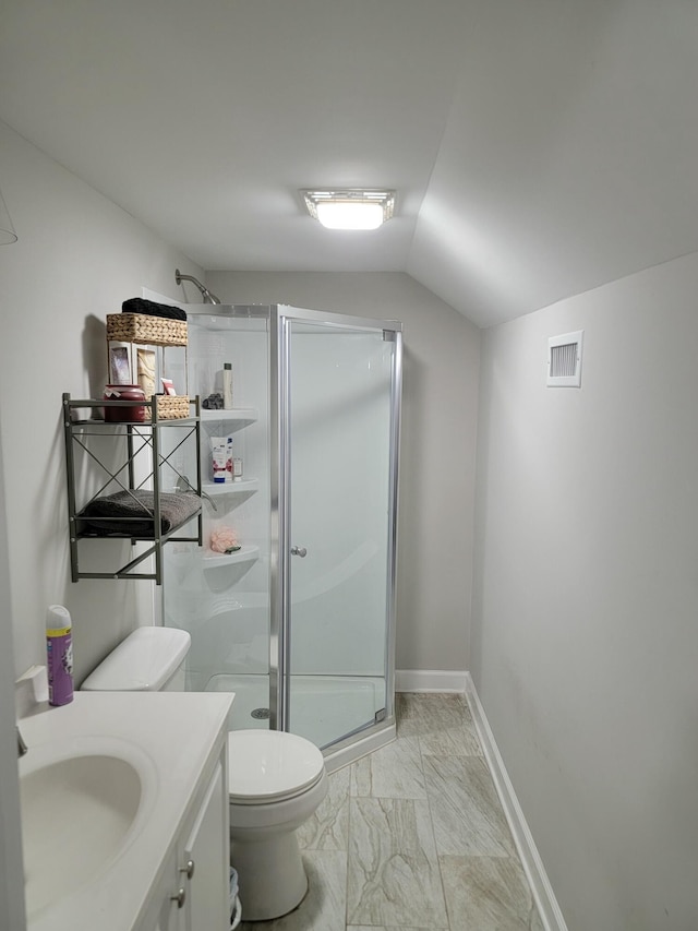 bathroom with lofted ceiling, vanity, toilet, and walk in shower