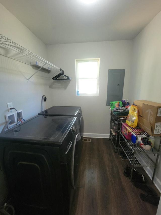 laundry area featuring dark wood-type flooring, independent washer and dryer, and electric panel