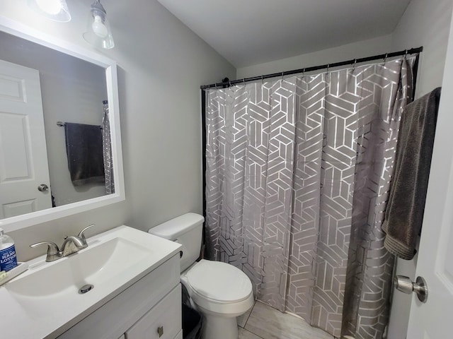 bathroom with vanity, toilet, and curtained shower