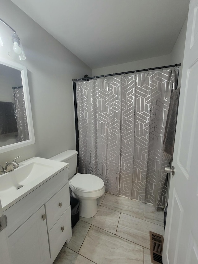 bathroom featuring vanity, a shower with shower curtain, and toilet