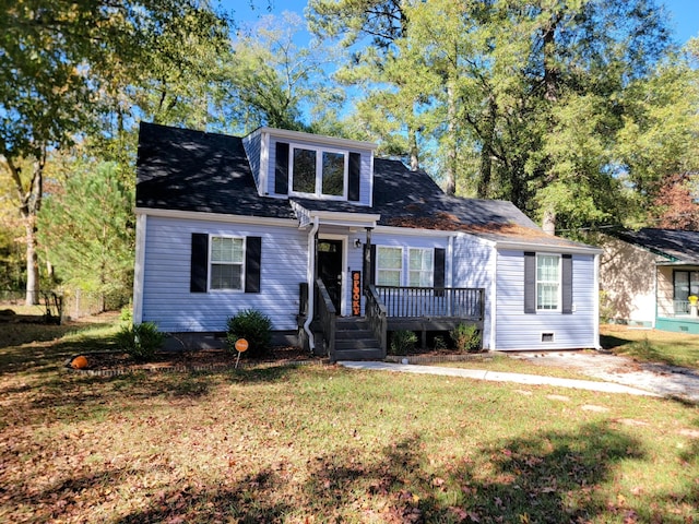 view of front of house with a deck and a front lawn