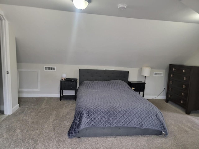 bedroom featuring lofted ceiling and carpet