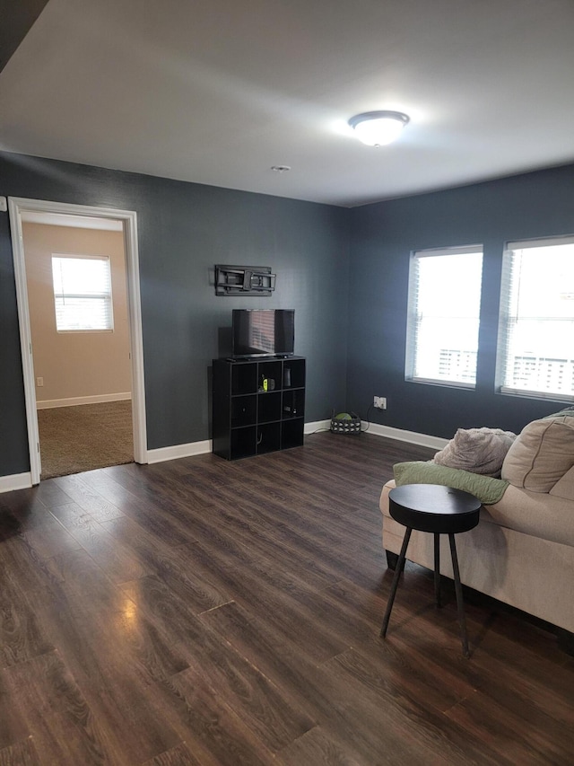 living room with plenty of natural light and dark hardwood / wood-style floors