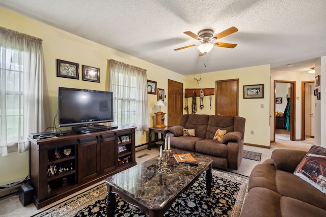 living room with plenty of natural light, light colored carpet, and a textured ceiling