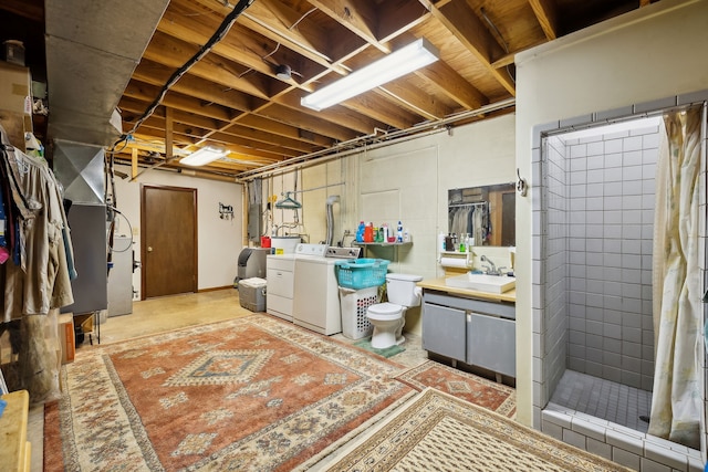 basement featuring washer and clothes dryer and sink