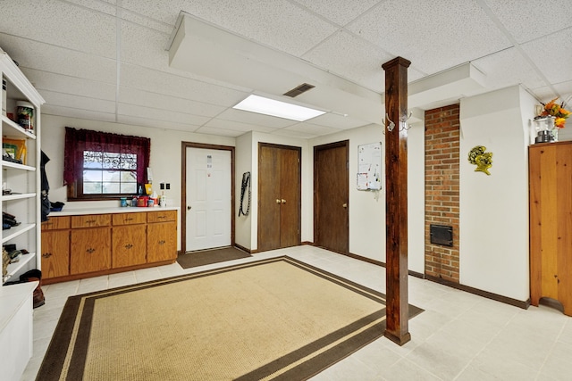 bedroom featuring a paneled ceiling and light tile patterned floors