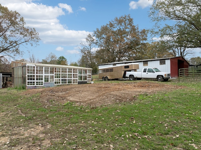 rear view of house featuring an outbuilding