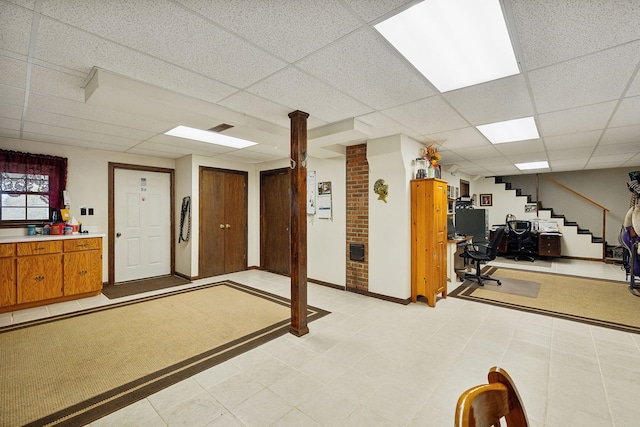 basement with a paneled ceiling