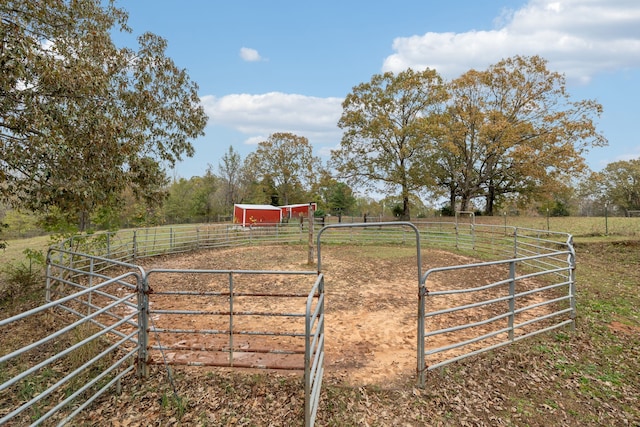 view of gate with a rural view and an outdoor structure