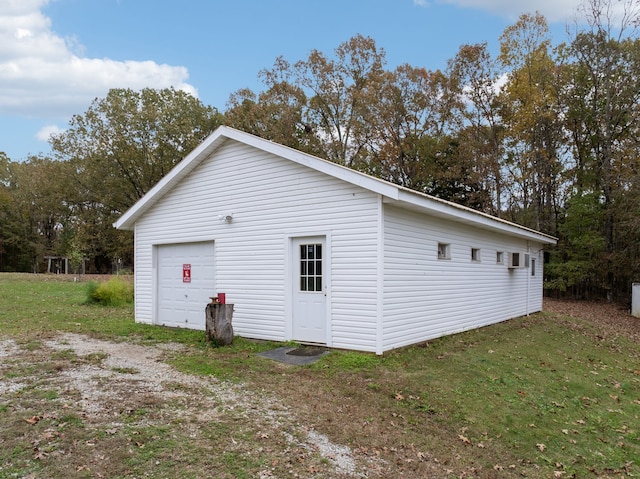 exterior space featuring a yard, an outbuilding, and a garage