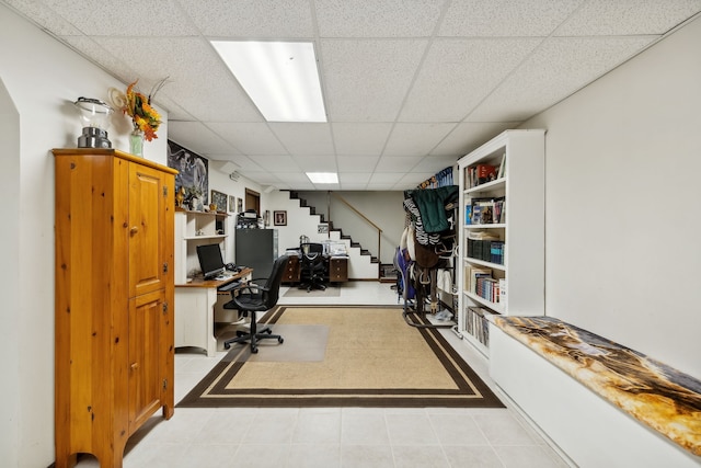 tiled home office with a drop ceiling