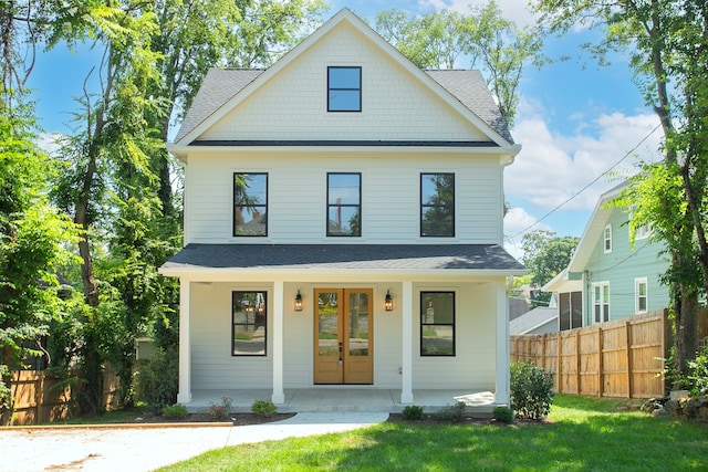 view of front facade featuring covered porch and a front lawn