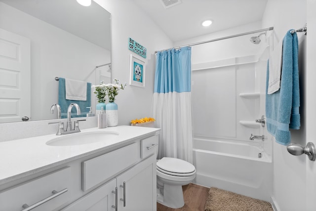 full bathroom featuring vanity, toilet, shower / bathtub combination with curtain, and hardwood / wood-style flooring