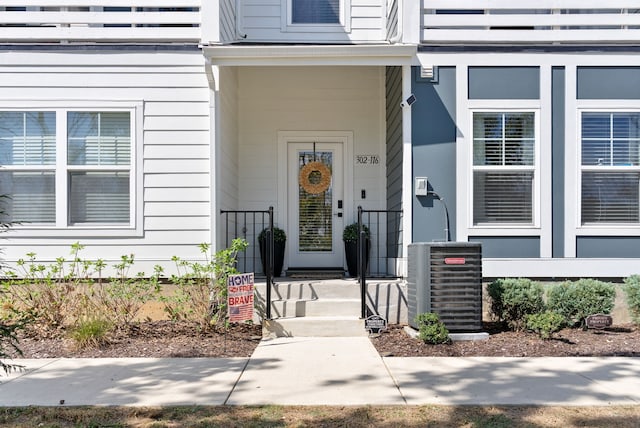 view of exterior entry featuring central AC unit