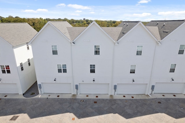 rear view of property with a garage