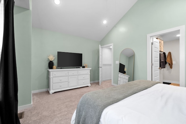 carpeted bedroom with high vaulted ceiling