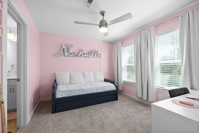 bedroom featuring multiple windows, ceiling fan, and light colored carpet