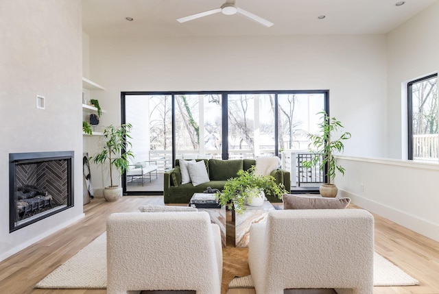 living room with ceiling fan and light hardwood / wood-style flooring