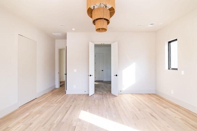 empty room with light hardwood / wood-style floors