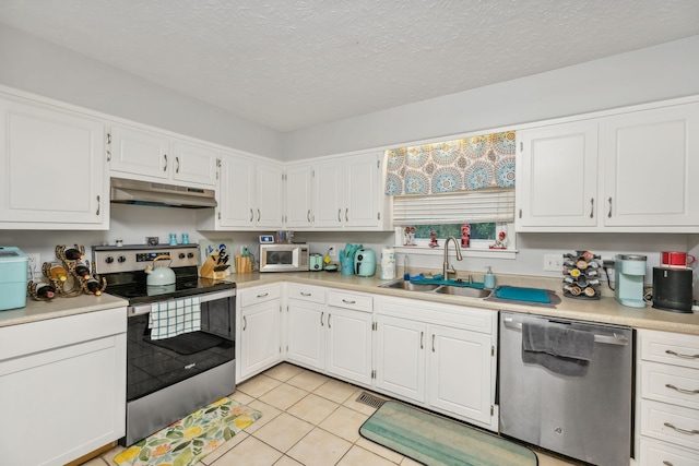 kitchen featuring sink, white cabinets, and appliances with stainless steel finishes