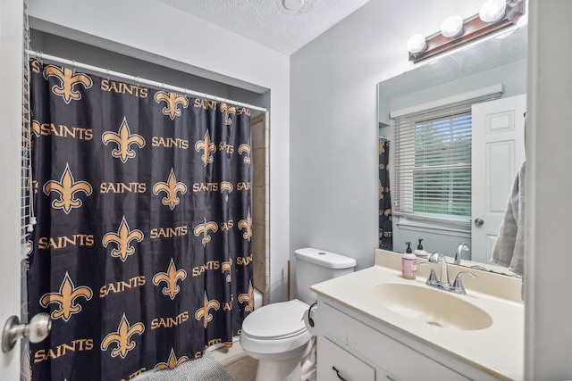 full bathroom with tile patterned floors, vanity, a textured ceiling, shower / bath combo with shower curtain, and toilet