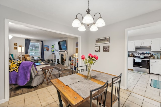 tiled dining area with a chandelier