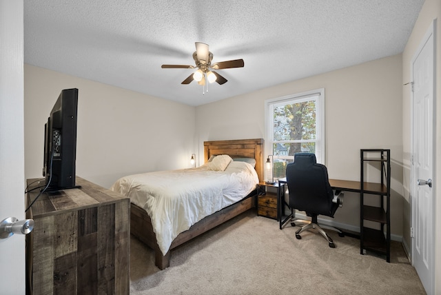 bedroom with carpet, ceiling fan, and a textured ceiling