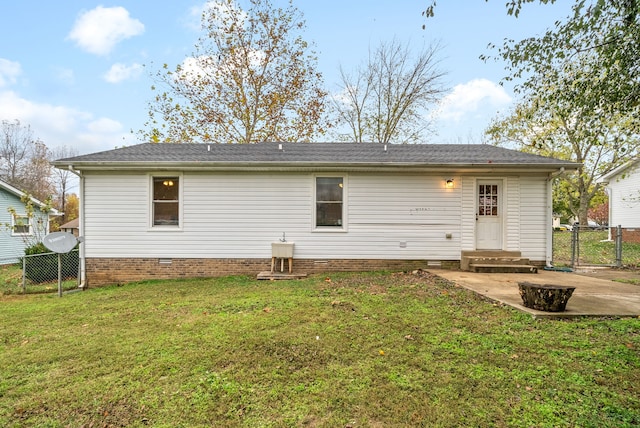 back of house with a patio and a lawn