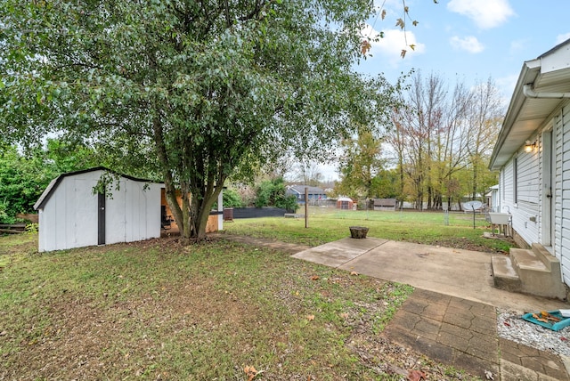 view of yard featuring a patio area and a storage shed