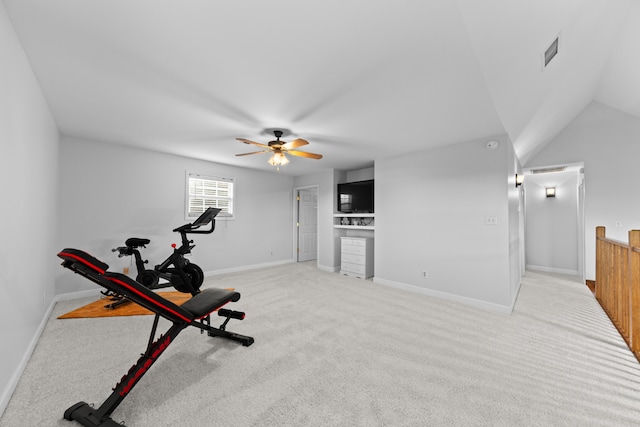 workout area with ceiling fan, light colored carpet, and lofted ceiling