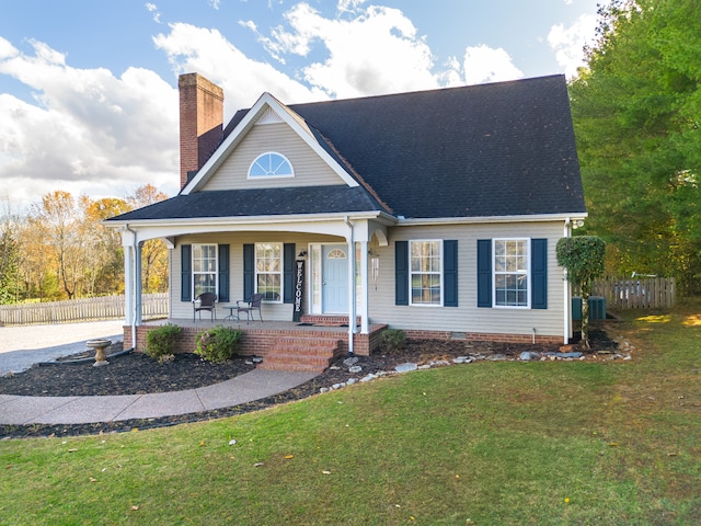 view of front of house with cooling unit, a front lawn, and a porch