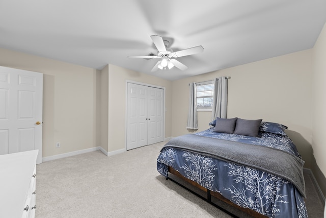 bedroom featuring ceiling fan, a closet, and light carpet