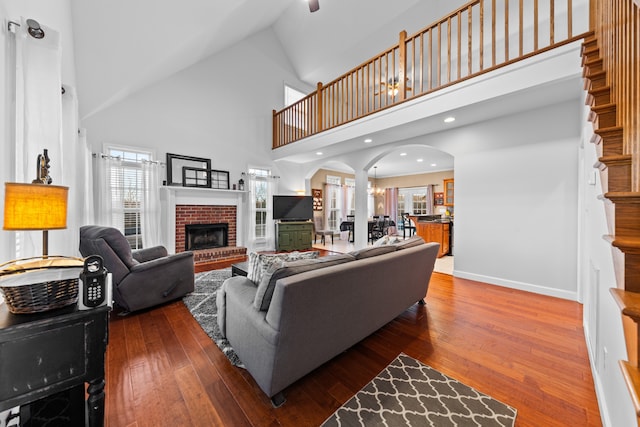 living room with hardwood / wood-style floors, plenty of natural light, and high vaulted ceiling