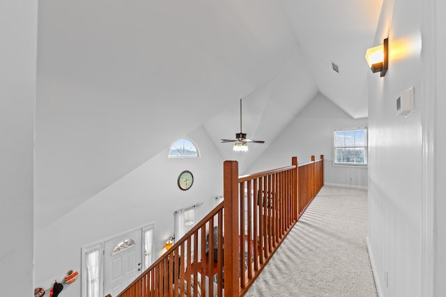 hall featuring light carpet and vaulted ceiling