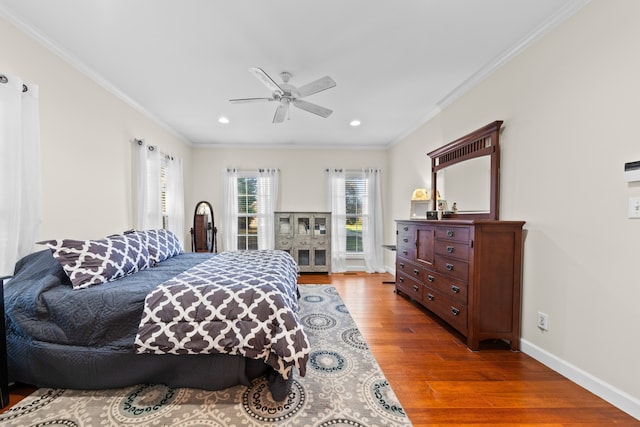 bedroom featuring ceiling fan, crown molding, and hardwood / wood-style flooring