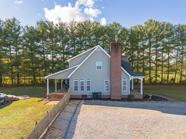 exterior space with covered porch and a yard