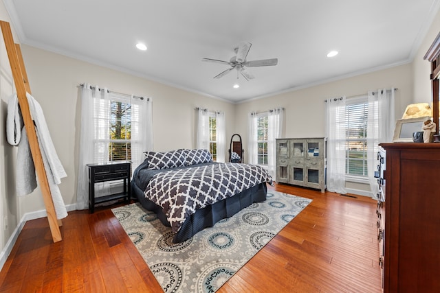 bedroom featuring multiple windows, crown molding, and dark hardwood / wood-style floors