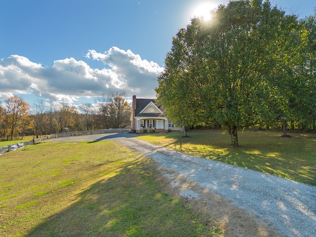 view of front of property with a rural view and a front lawn